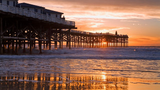 Pier sunset waves crashing person - a pier free wallpaper for desktop