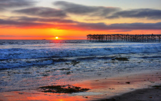 Sunset ocean pier waves crashing - a pier in the distance free wallpaper