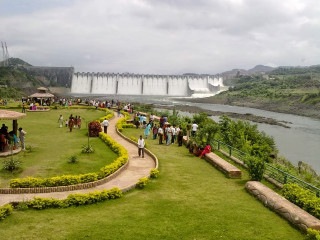 Group people waterfall green field - a waterfall in the background free wallpaper for desktop