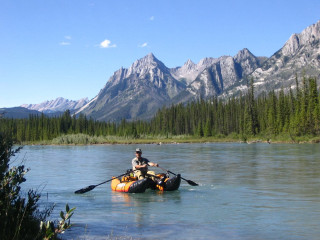 Man paddling raft river mountains - douglas robertson bisset free wallpaper