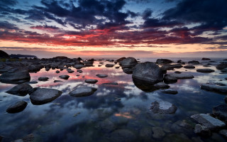 Sunset rocky beach clouds reflection - the water and a sky free wallpaper