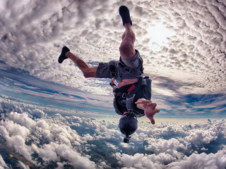 Man skydiving clouds feet up - his foot free wallpaper