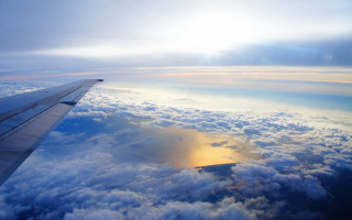 Airplane wing clouds water sun - a bright sun free wallpaper