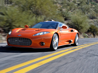 Orange sports car driving road - a orange sports car free wallpaper
