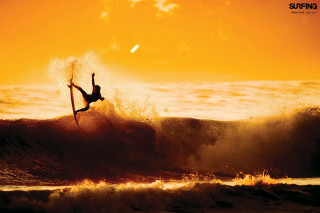 Surfer jumping off wave sunset - the sun shining behind free wallpaper