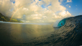 Person riding wave surfboard rainbow - under free wallpaper