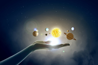 Hand holding solar system planets - a solar system free wallpaper
