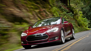 Red tesla car driving woods - the car free wallpaper