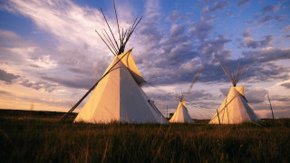 Teepees field cloudy sky grass - a field under a cloudy sky free wallpaper