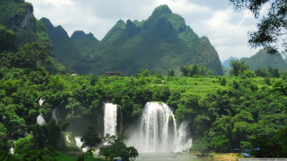 Waterfall forest boat water mountains - a waterfall in the middle of a forest free wallpaper