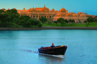 Man boat lake large building - a man in a boat free wallpaper
