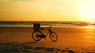 Bike beach sunset ocean parked - the background and the ocean in the foreground free wallpaper