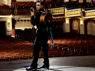 Man holding guitar auditorium microphone - his hand and a microphone free wallpaper