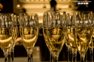 Champagne glasses table person background - a person in the background free wallpaper