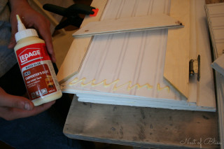 Person painting white door glue - a door free wallpaper