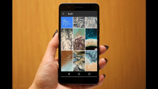 Person holding cell phone image - screen free wallpaper