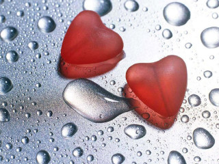 Two red hearts wet surface - a drop of water free wallpaper