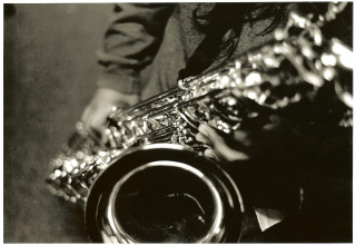 Saxophone player table black white - a person playing free wallpaper