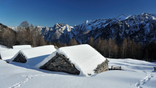 Snow covered mountain cabin bench - a bench in the foreground free wallpaper