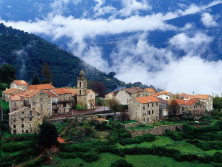 Village surrounded by mountains clouds - a village free wallpaper for desktop