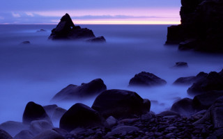 Rocky beach purple sky clouds 3 - a purple sky in the background free wallpaper