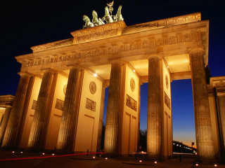 Large building columns statues nighttime 2 - the side of the building free wallpaper for desktop