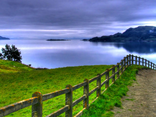Wooden fence grassy hill lake - a lake and mountains free wallpaper