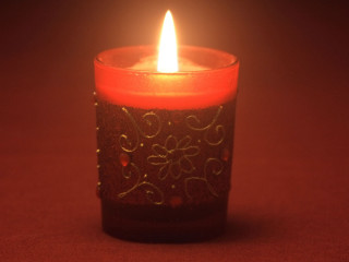 Lit candle red background white - free light wallpaper