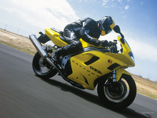 Man riding yellow motorcycle street - a yellow motorcycle free wallpaper