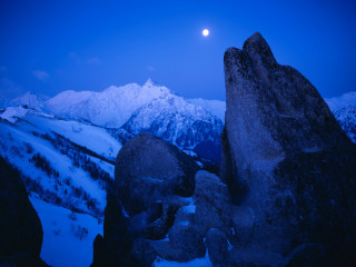 Full moon snowy mountain rock 2 - a large rock formation free wallpaper