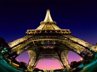 Eiffel tower lit up night - the side of it free wallpaper