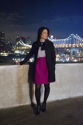 Woman standing ledged city skyline - her arm free wallpaper for mobile