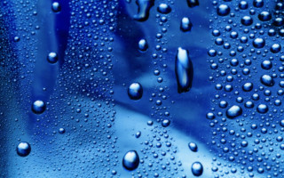 Water droplets blue surface background 2 - a close up of water droplets free wallpaper