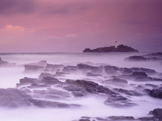 Lighthouse rocky shore pink sky - rich moody colour free wallpaper