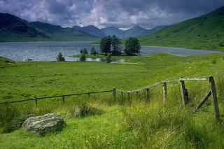 Grassy field wooden fence lake 2 - alexander johnston free wallpaper