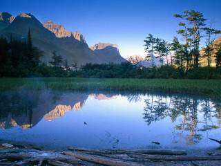 Lake mountains trees logs foreground 3 - douglas robertson bisset free wallpaper
