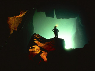 Person standing rock cave light 3 - atmospheric free wallpaper