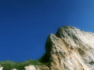 Rock formation bird flying blue - a rock formation free wallpaper