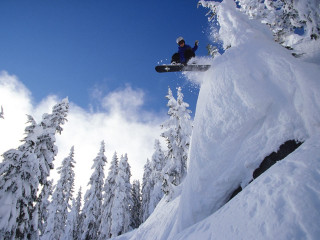 Snowboarder jumping snowy mountain air - a snowboarder free wallpaper