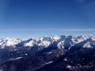 Mountain range airplane window blue - an airplane window free wallpaper
