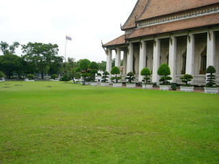Grassy field building flagpole trees - asai chū free wallpaper