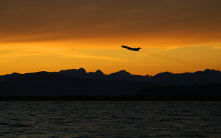 Plane flying water sunset mountains - over the water free wallpaper