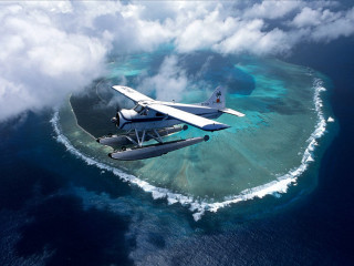 Plane flying small island ocean - beautiful scenery free wallpaper for desktop