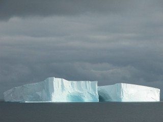 Large iceberg floating ocean cloudy - the ocean under a cloudy sky free wallpaper