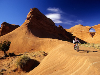 Man riding bike desert mountains - kodachrome free wallpaper