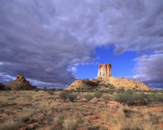 Large rock formation desert cloudy - a few bush and bushes free wallpaper