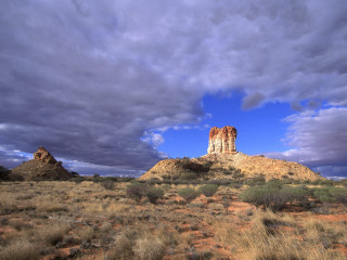 Large rock formation desert cloudy 3 - a few bush and bushes free wallpaper