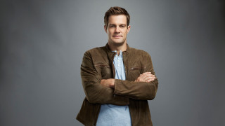 Man arms crossed brown jacket - blue shirt free wallpaper