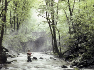 Man river fishing holding fish 2 - a fish free wallpaper