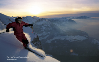 Man red snow suit skiing - the sun behind free wallpaper